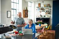 Couple retirement planning in their kitchen.