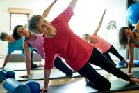 women over 60 doing yoga for the health benefits.