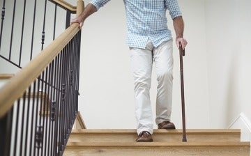 Man with a cane descending the stairs