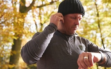Man checking activity tracker during a run