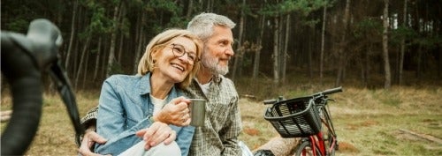 older couple outside drinking tea