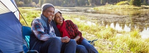 couple camping by a river