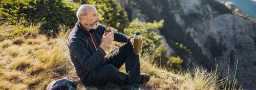 Man drinking tea on a mountain
