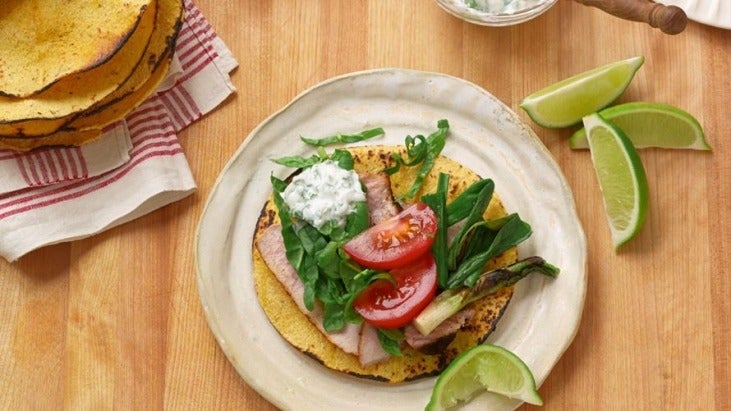 Pork and green onion tacos on a plate